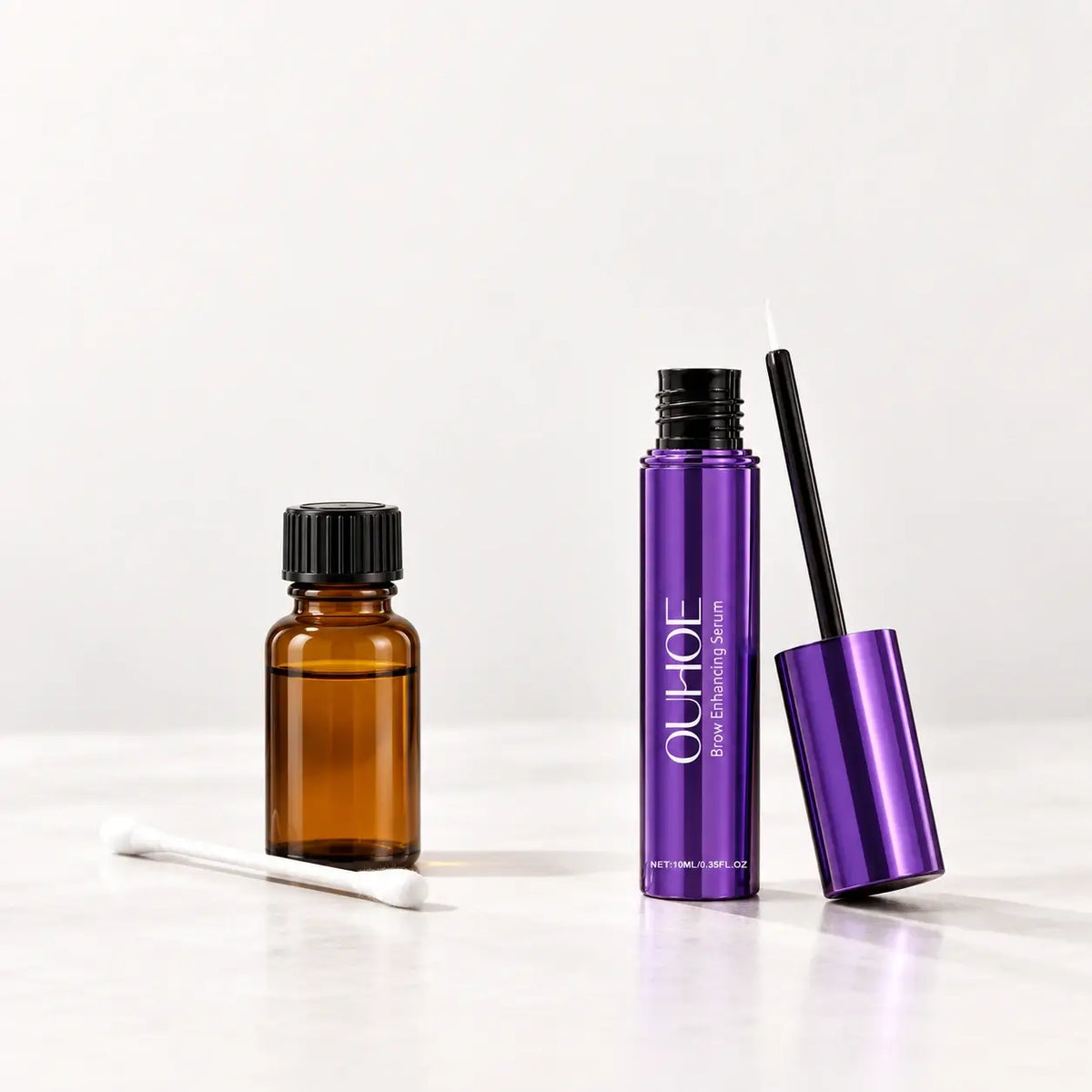 Separate oil bottle and cotton bud beside Densyra’s purple bottle and included fine brush