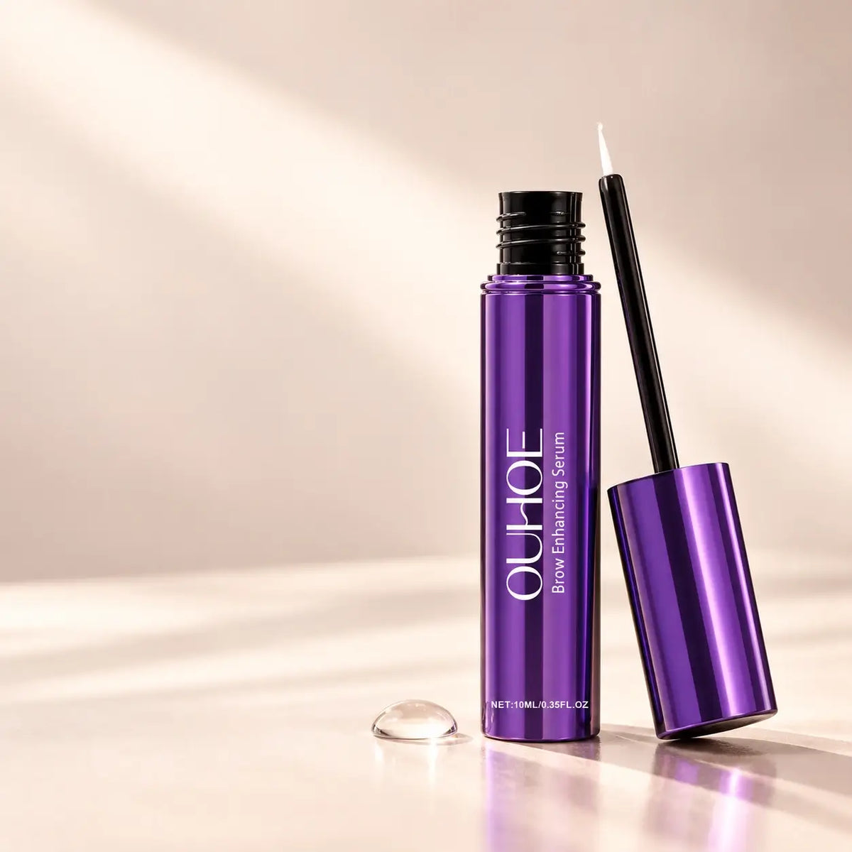 Purple OUHOE brow serum and its fine-tip brush