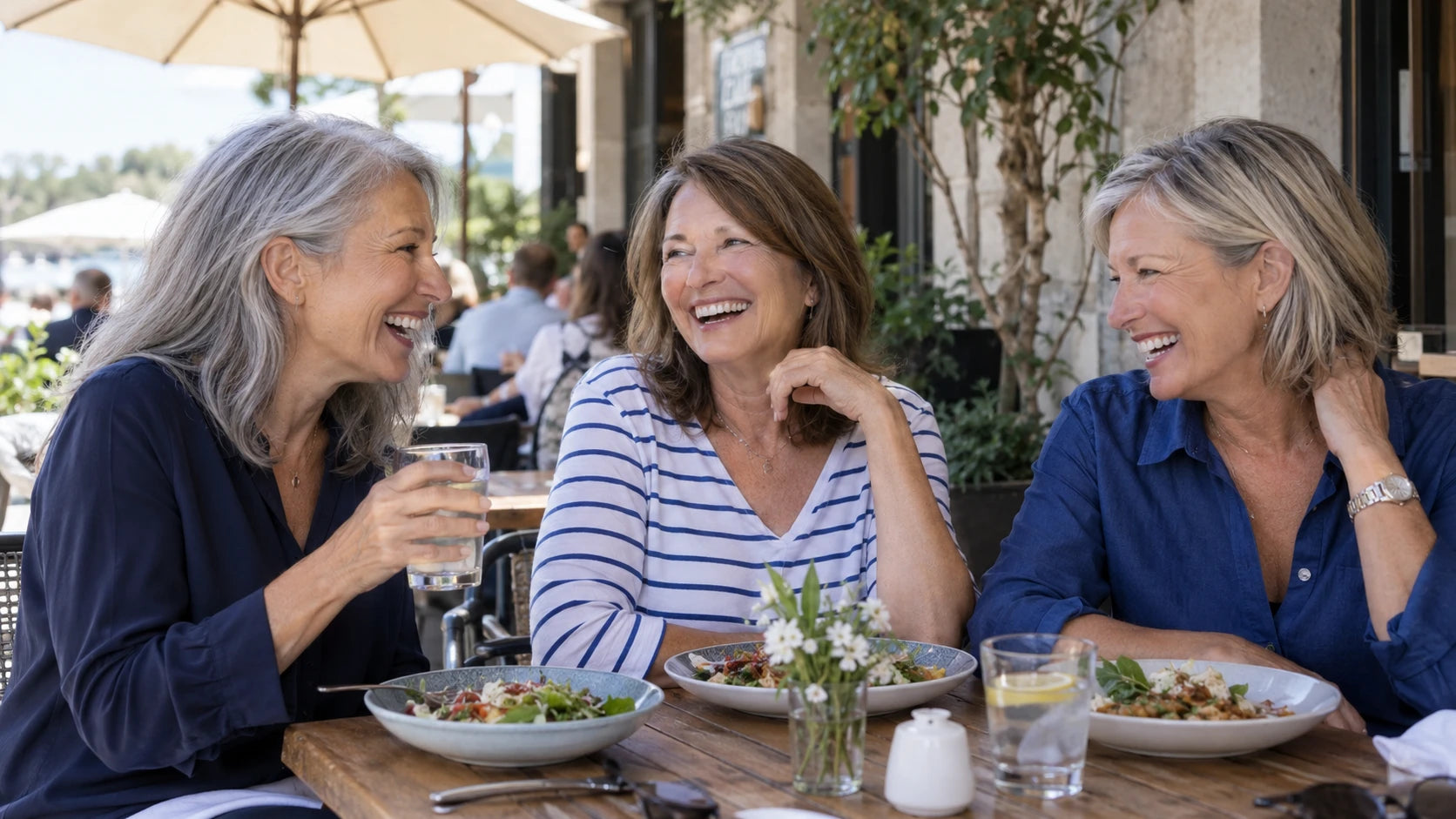 Mature friends enjoying a relaxed cafe lunch