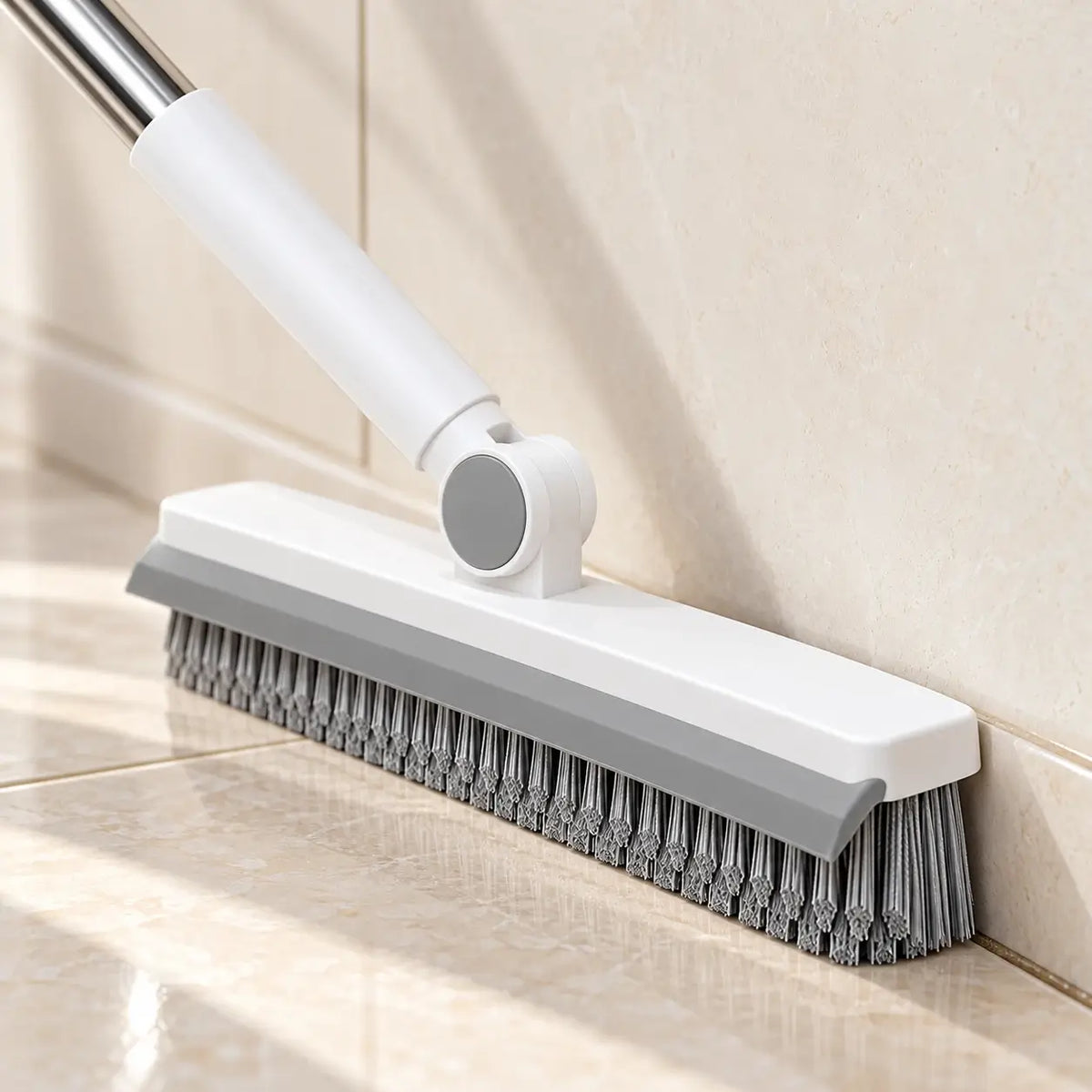 White and gray pivot connection with the handle angled along a floor edge