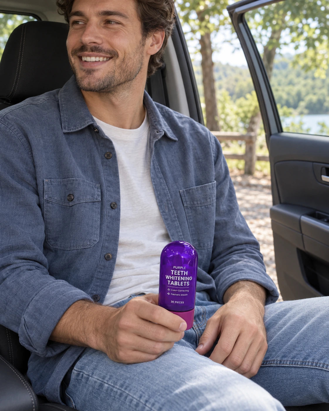 A man in a parked car holding the bottle before arriving